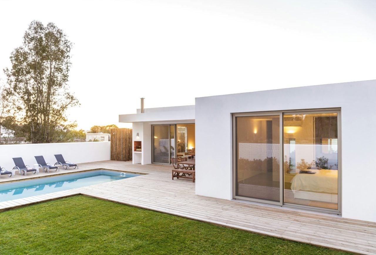 modern house with garden swimming pool and wooden deck